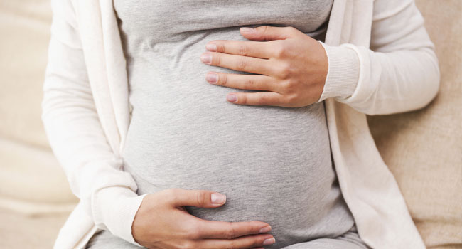 Pregnant Women Grabbing Stomach